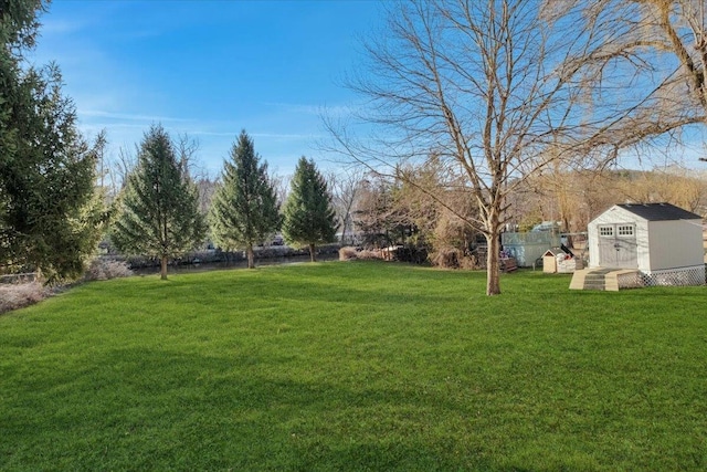 view of yard with an outbuilding and a shed