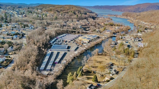 drone / aerial view with a water and mountain view