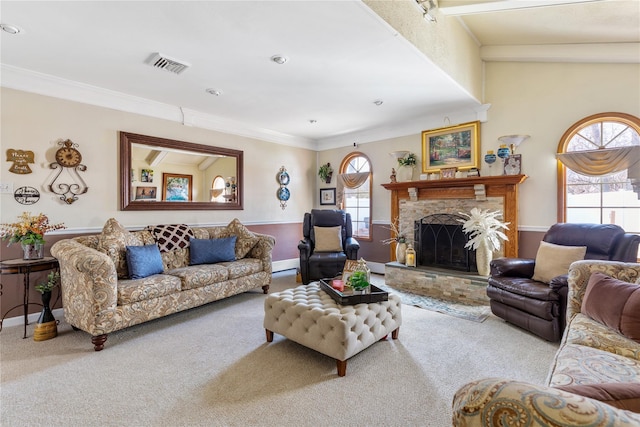 living area featuring carpet floors, visible vents, a fireplace, and ornamental molding