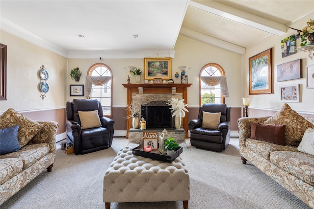 living room with carpet floors, a wealth of natural light, a stone fireplace, and lofted ceiling with beams