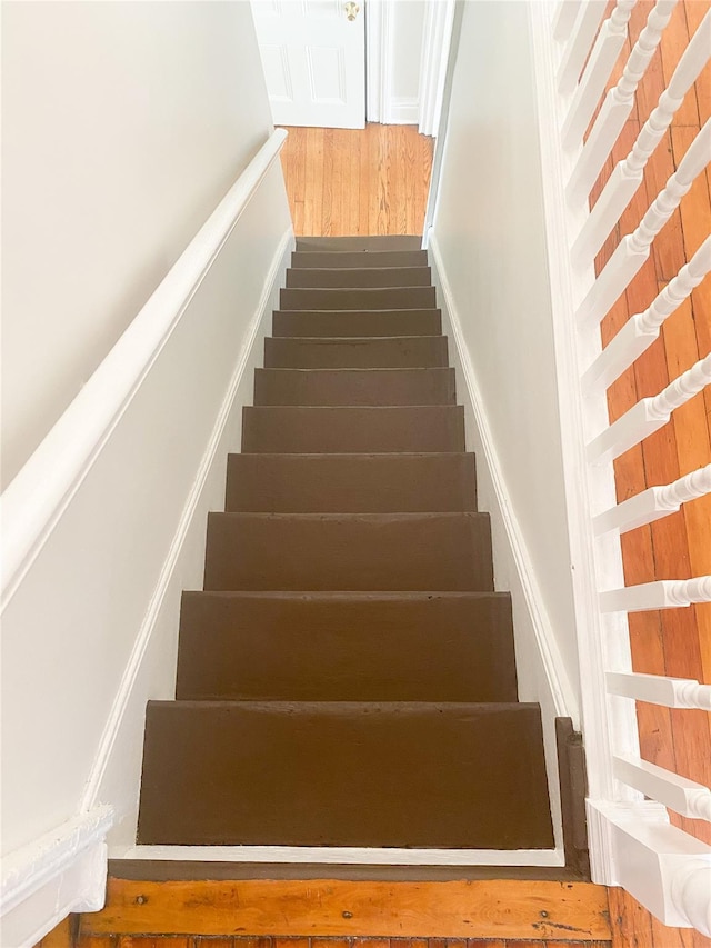 stairway with wood finished floors