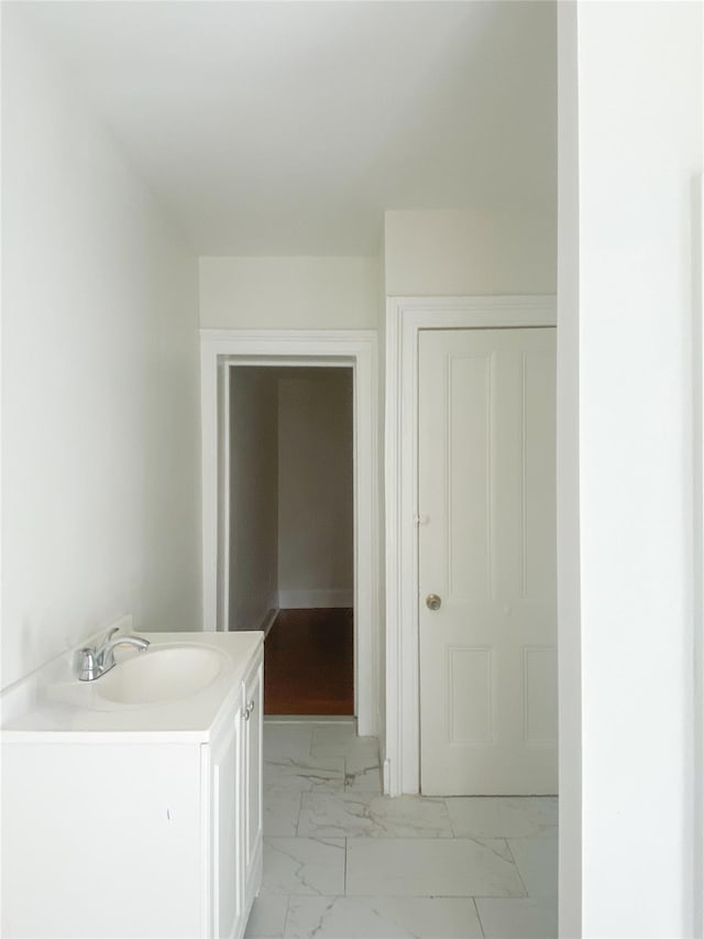 bathroom featuring marble finish floor and vanity