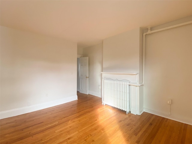 empty room featuring baseboards and light wood-style floors