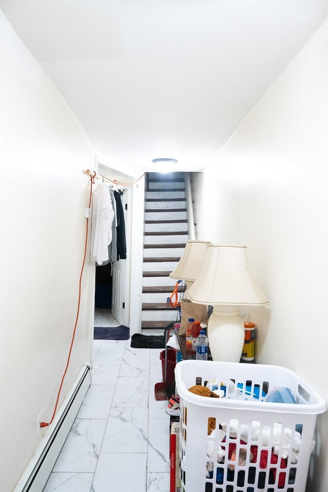 staircase with marble finish floor and a baseboard radiator