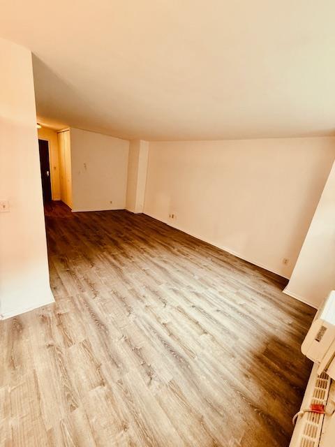 empty room featuring vaulted ceiling and wood finished floors