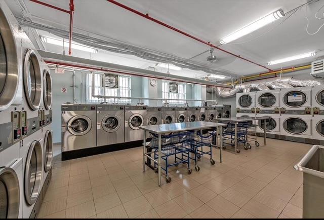 common laundry area featuring tile patterned floors, washing machine and dryer, and stacked washer and clothes dryer