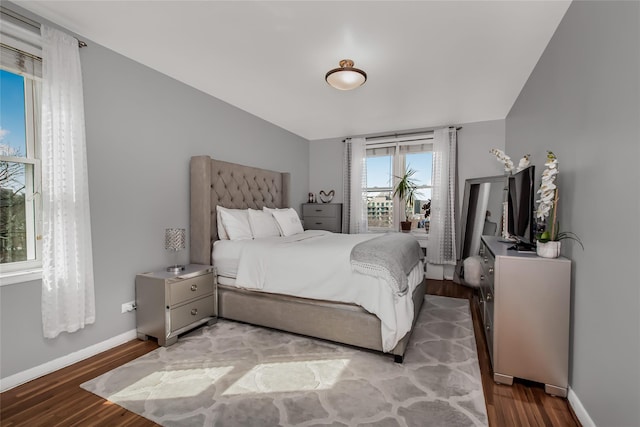 bedroom with baseboards and wood finished floors