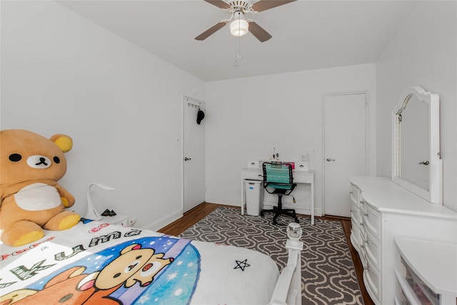 bedroom featuring ceiling fan, wood finished floors, and baseboards