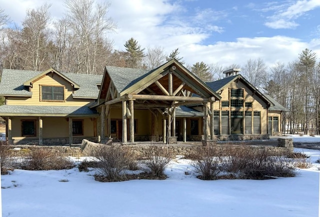 view of front of property featuring covered porch and roof with shingles