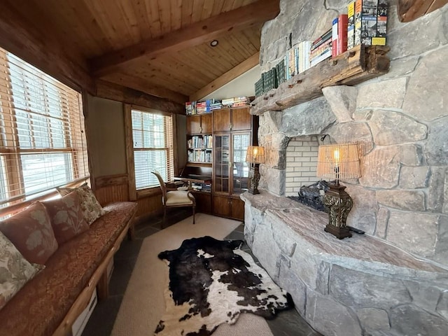 interior space featuring vaulted ceiling with beams, wooden ceiling, carpet floors, and wainscoting