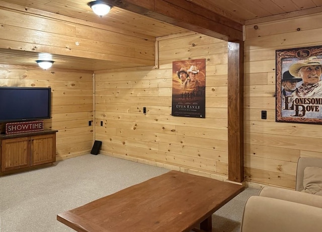 living area featuring wooden ceiling, carpet flooring, and wooden walls