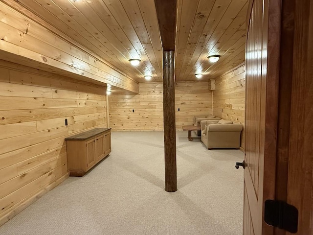 finished basement with wood walls, wood ceiling, and light colored carpet