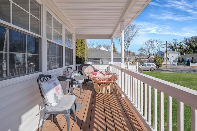 deck featuring a residential view and a porch