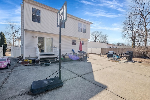 back of house with a patio area and fence