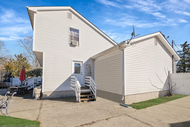 back of property featuring a patio and fence