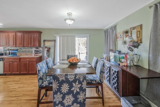 dining space with light wood-style flooring