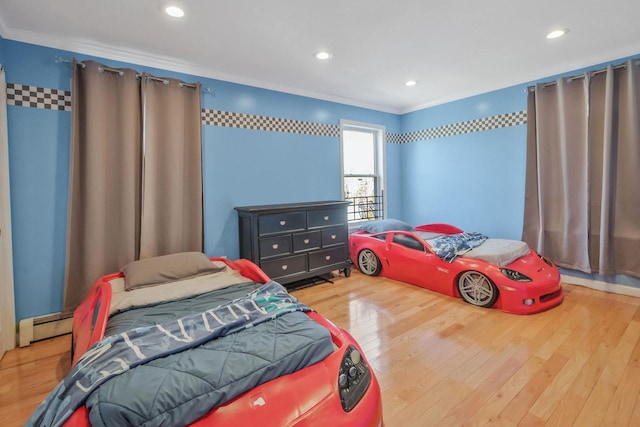 bedroom featuring a baseboard heating unit, recessed lighting, crown molding, and wood finished floors