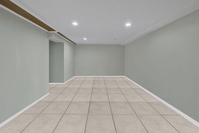 empty room with recessed lighting, light tile patterned flooring, and baseboards