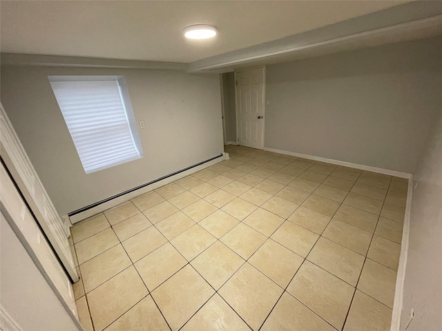 empty room with baseboards, baseboard heating, and light tile patterned floors