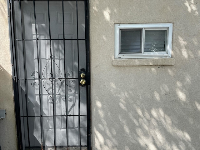 view of exterior entry with stucco siding