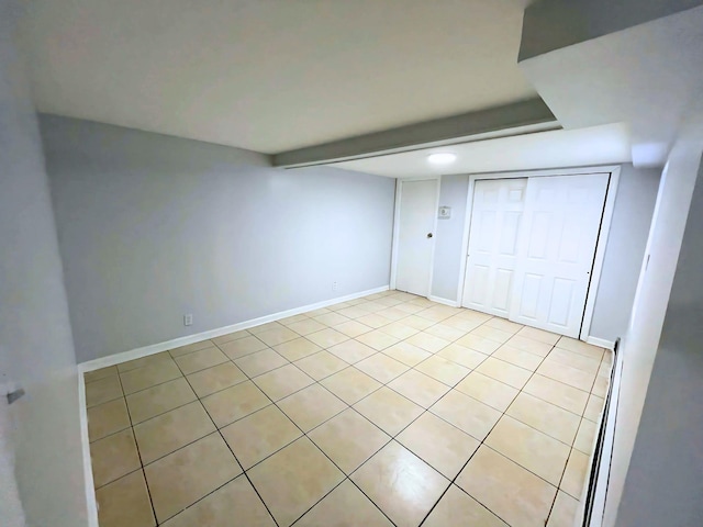 unfurnished bedroom with light tile patterned floors and baseboards