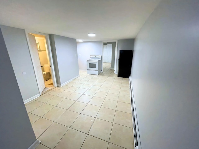 empty room featuring light tile patterned flooring and baseboards