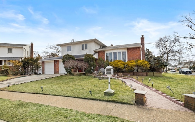 tri-level home featuring concrete driveway, brick siding, a chimney, and a front lawn