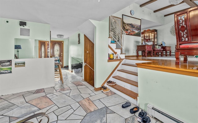 interior space with stairs, beamed ceiling, a baseboard radiator, and stone tile floors