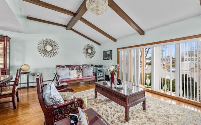 living area featuring vaulted ceiling with beams and wood finished floors