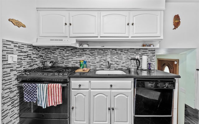 kitchen with white cabinets, dark countertops, under cabinet range hood, black appliances, and a sink