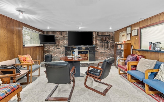 carpeted living room with wood walls and a fireplace