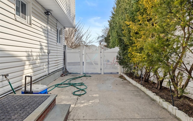 view of patio with a gate and fence