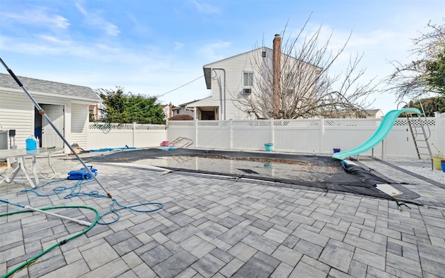 view of patio / terrace with an outbuilding and a fenced backyard