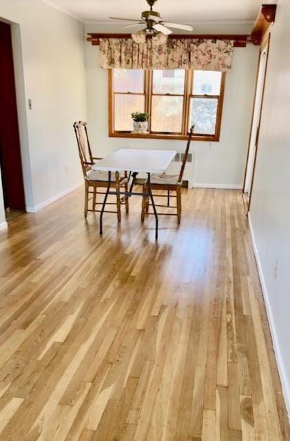 unfurnished dining area with crown molding, light wood-type flooring, a ceiling fan, and a healthy amount of sunlight