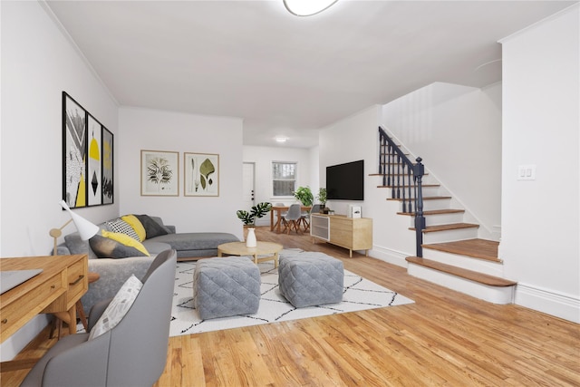 living area featuring stairway, wood finished floors, and baseboards