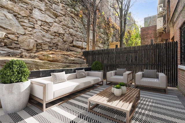 view of patio / terrace with an outdoor hangout area and fence