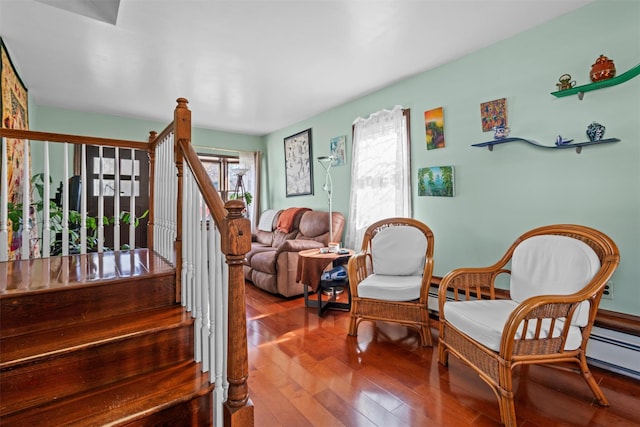 sitting room with wood-type flooring and stairs