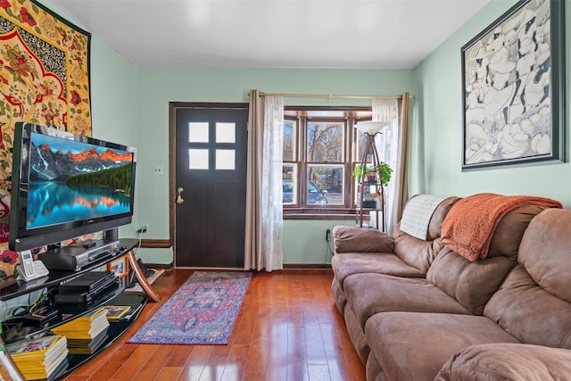 living room with hardwood / wood-style floors and baseboards