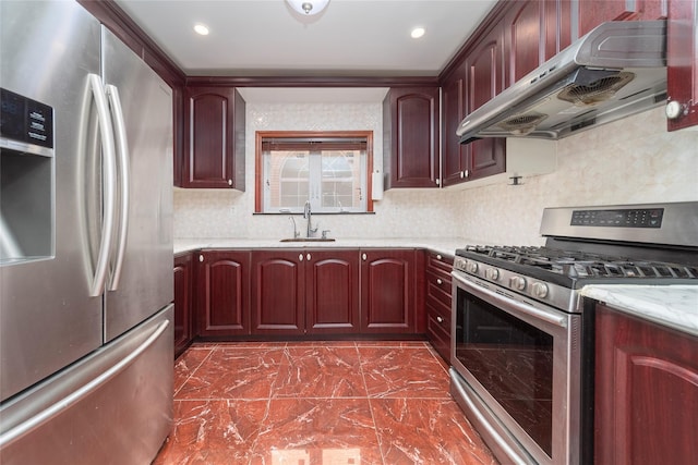 kitchen featuring under cabinet range hood, a sink, dark brown cabinets, appliances with stainless steel finishes, and tasteful backsplash