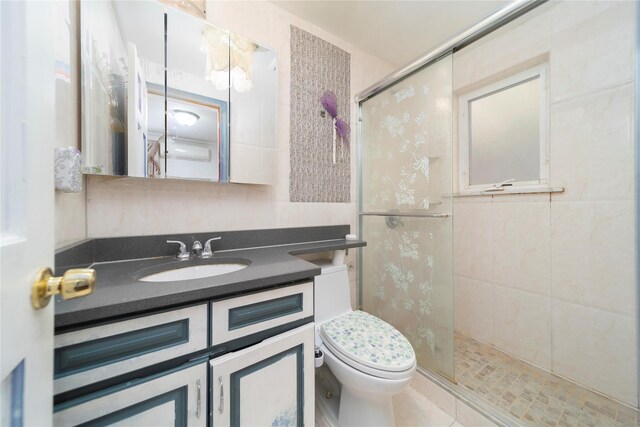 full bathroom featuring toilet, a stall shower, and vanity