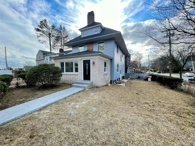 american foursquare style home with entry steps, a chimney, and fence