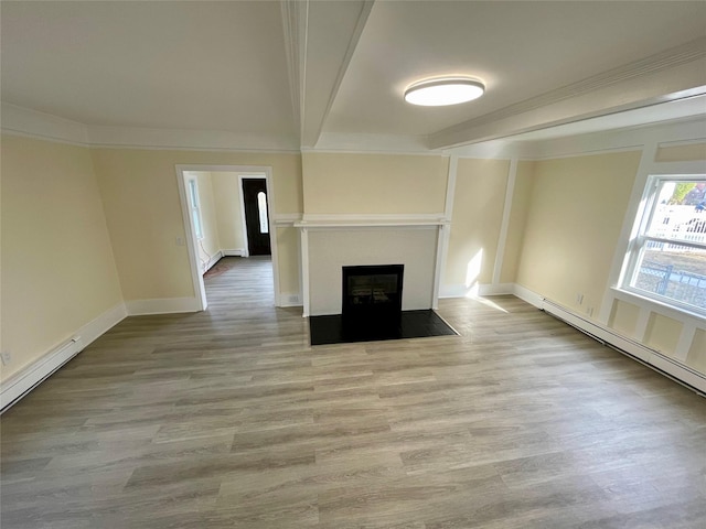 unfurnished living room with a fireplace with flush hearth, beam ceiling, baseboards, and wood finished floors