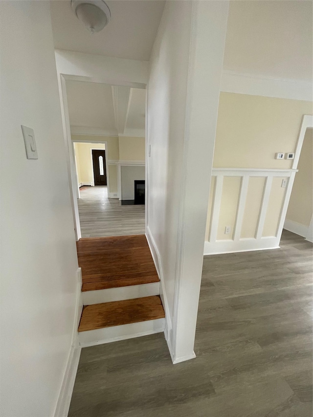 stairway featuring wood finished floors and baseboards