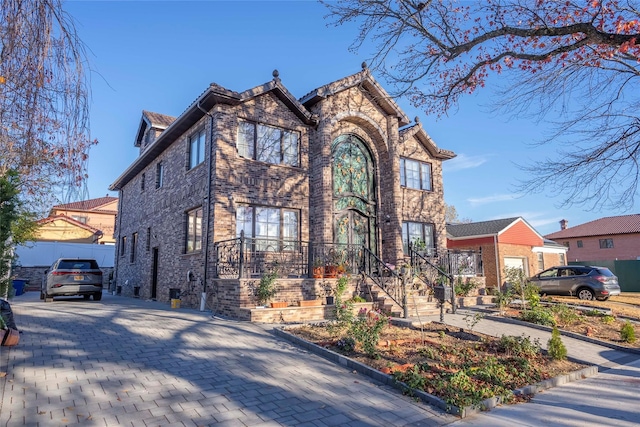 view of front of house with stone siding and brick siding