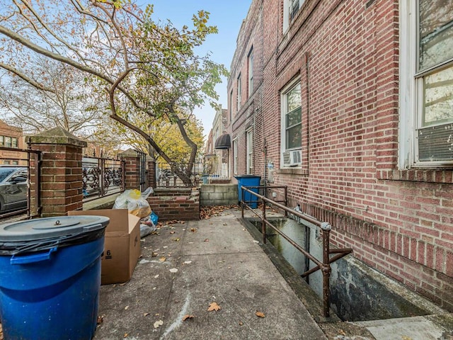 exterior space featuring cooling unit and brick siding