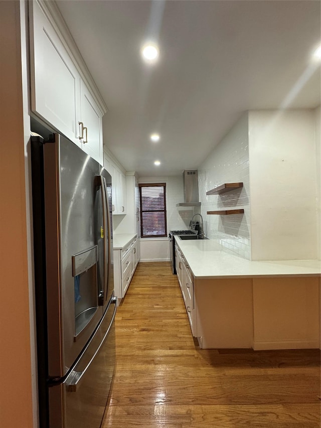 2860 Bailey Ave Unit 7L, Bronx, NY 10463 - kitchen with stainless steel fridge with ice dispenser, wall chimney exhaust hood, open shelves, white cabinets, and light wood-style flooring
