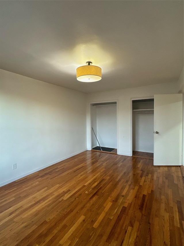 2860 Bailey Ave Unit 7L, Bronx, NY 10463 - unfurnished bedroom featuring two closets and dark wood-style floors
