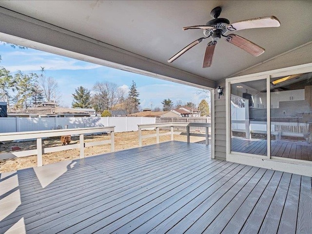 wooden deck with a fenced backyard and ceiling fan