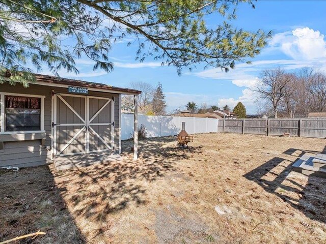 view of yard with an outbuilding and a fenced backyard