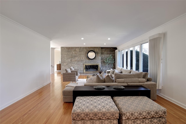 living room with a fireplace, crown molding, light wood finished floors, recessed lighting, and baseboards